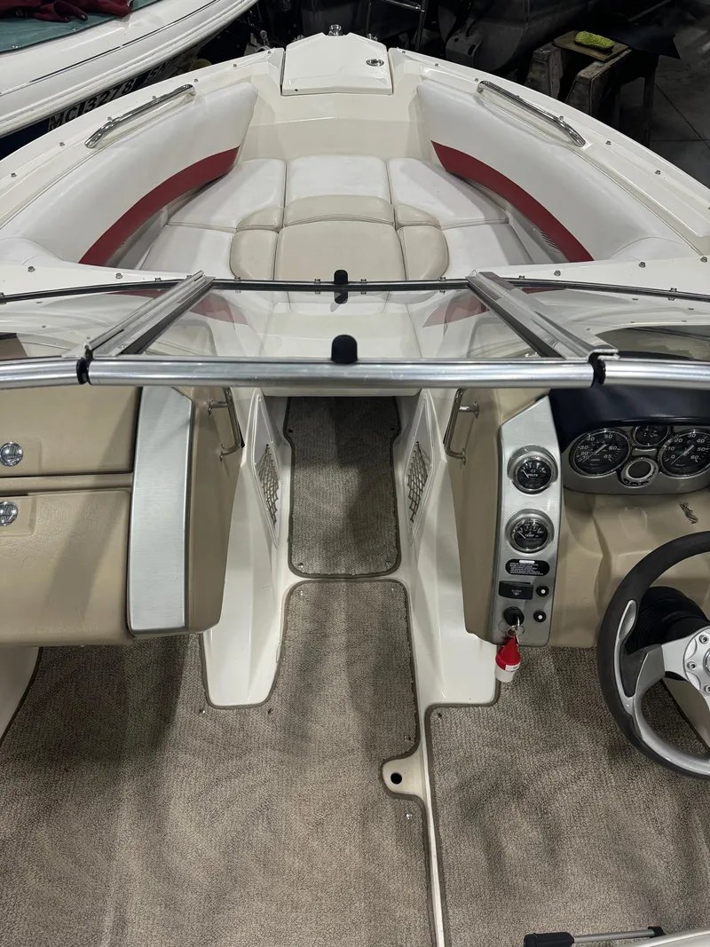 Slide: The Image of Interior view of 2007 Larson LXi 208 boat with beige and red seating. - 6
