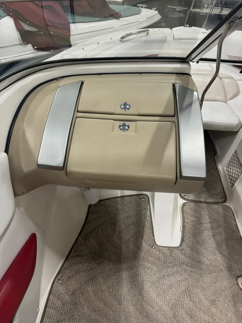 Slide: The Image of 2007 Larson LXi 208 boat interior with beige dashboard and carpeted flooring. - 8