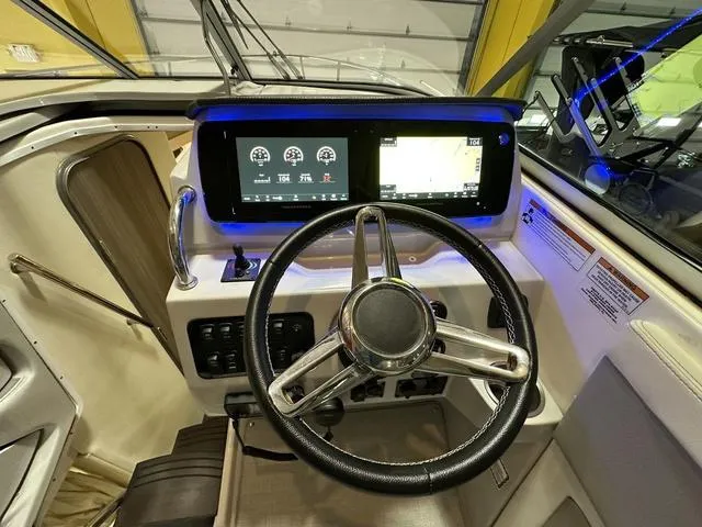 Slide: The Image of 2022 Regal 28 Express boat dashboard with modern steering and digital displays. - 10
