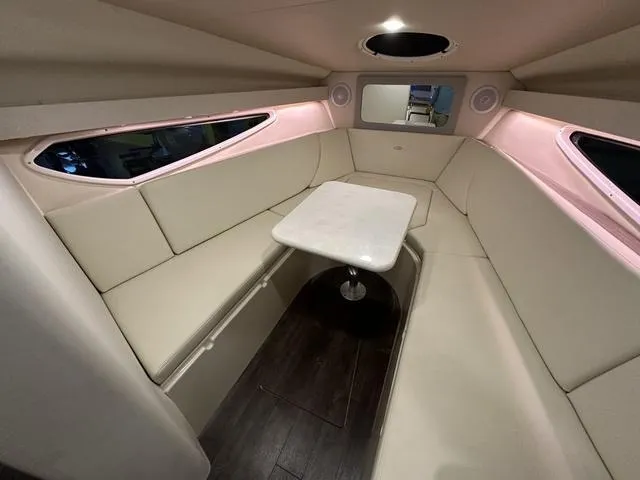 Slide: The Image of Interior of 2022 Regal 28 Express boat with beige seating and table. - 13
