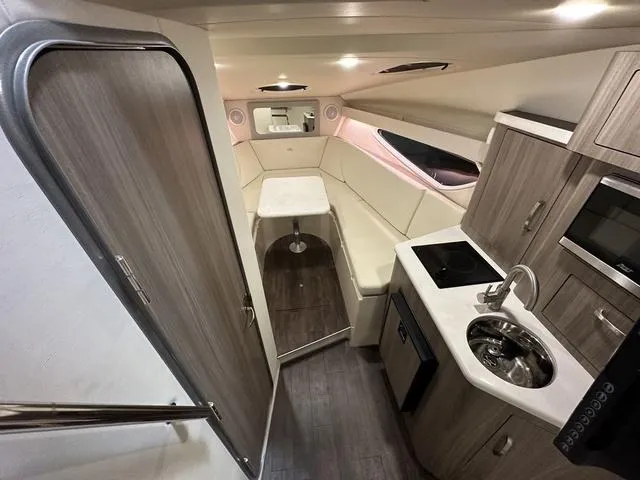 Slide: The Image of 2022 Regal 28 Express cabin interior with kitchenette, seating, and modern amenities. - 16