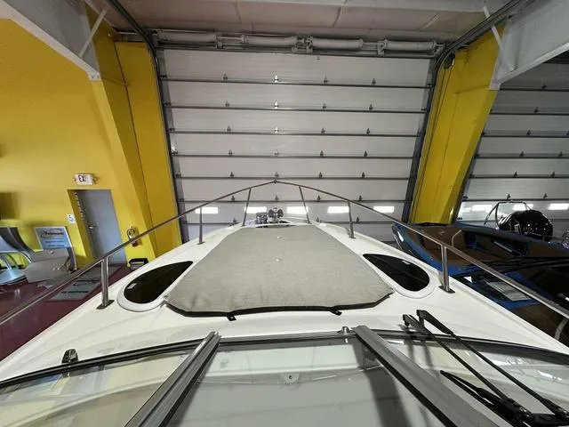 Slide: The Image of 2022 Regal 28 Express boat in indoor storage, showcasing sleek design and spacious deck. - 17