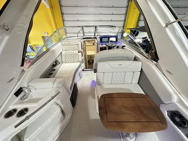Slide: The Image of 2022 Regal 28 Express boat interior with seating and wooden table. - 19