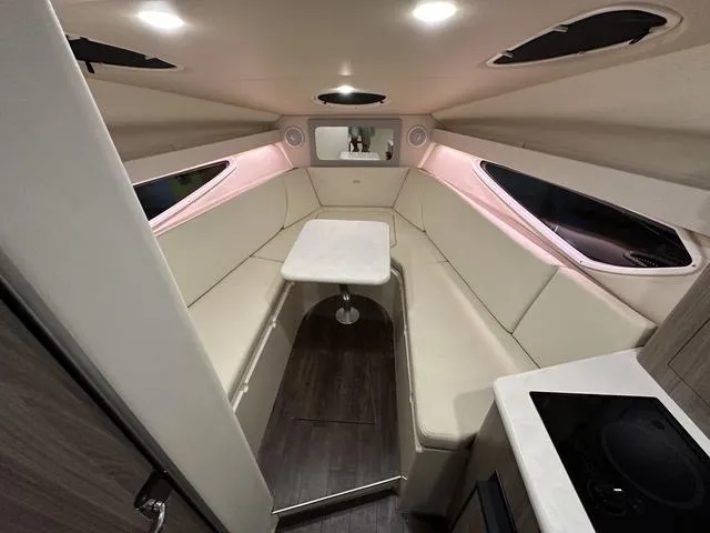 Slide: The Image of 2022 Regal 28 Express cabin interior with modern seating and table setup. - 2