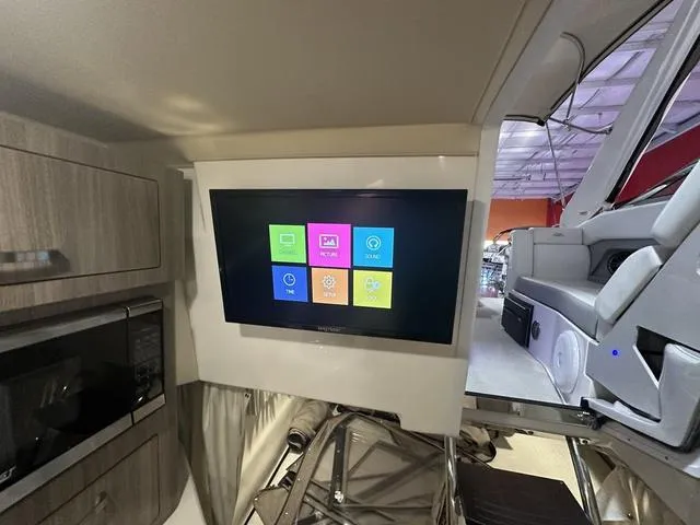 Slide: The Image of Interior of 2022 Regal 28 Express boat with mounted TV and modern amenities. - 21