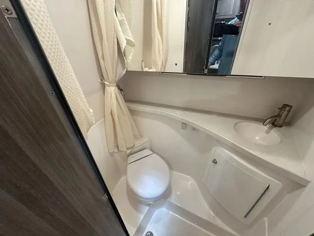 Slide: The Image of 2022 Regal 28 Express bathroom with shower, sink, and toilet. - 23