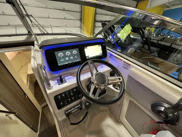 Slide: The Image of 2022 Regal 28 Express boat cockpit with modern steering and digital display. - 3