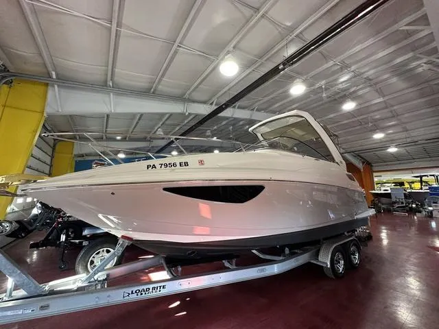 Slide: The Image of 2022 Regal 28 Express boat on trailer in indoor showroom. - 4