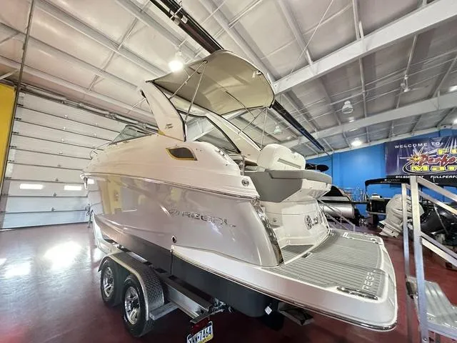 Slide: The Image of 2022 Regal 28 Express boat in showroom, on trailer, under bright lighting. - 5