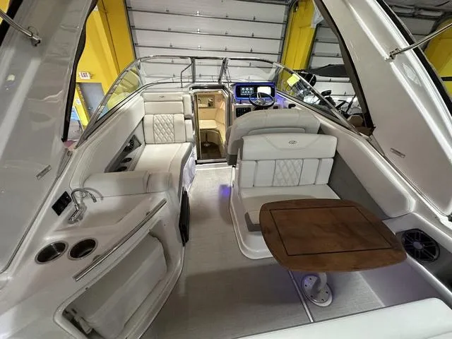 Slide: The Image of 2022 Regal 28 Express boat interior with seating and wooden table. - 7