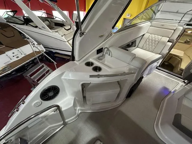 Slide: The Image of 2022 Regal 28 Express boat interior with seating, sink, and cup holders. - 8