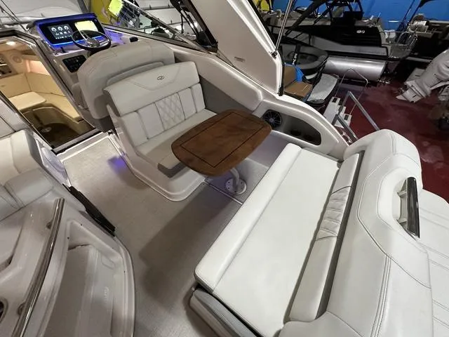 Slide: The Image of 2022 Regal 28 Express boat interior with white seating and wooden table. - 9