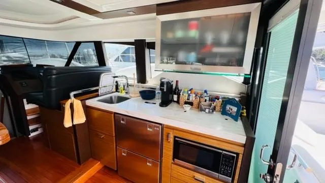 Slide: The Image of Interior of 2017 Tiara Yachts 44 Coupe with modern kitchen amenities. - 18