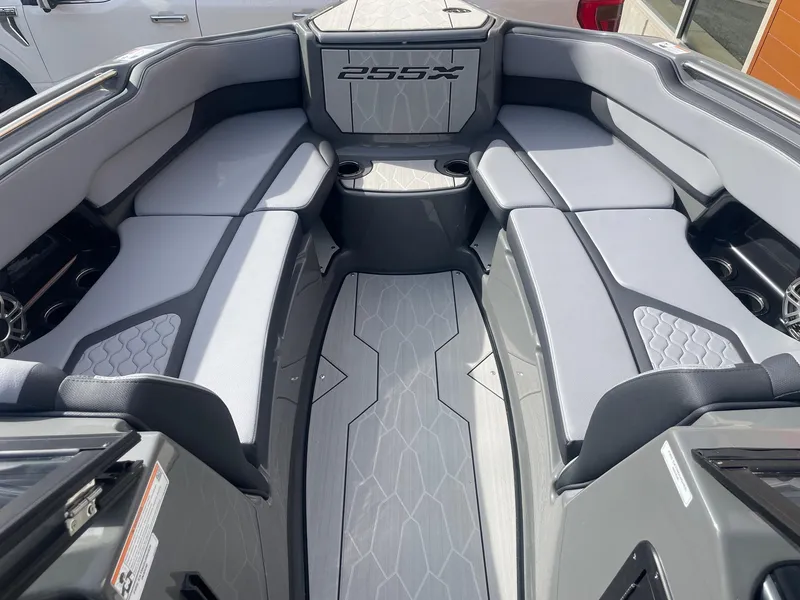 Slide: The Image of 2025 Yamaha Boats 255XE interior with sleek gray seating and modern design. - 11