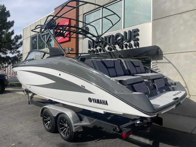 Slide: The Image of 2025 Yamaha Boats 255XE on trailer outside dealership. - 3