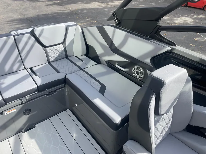 Slide: The Image of 2025 Yamaha Boats 255XE interior with sleek gray seating and modern design. - 9
