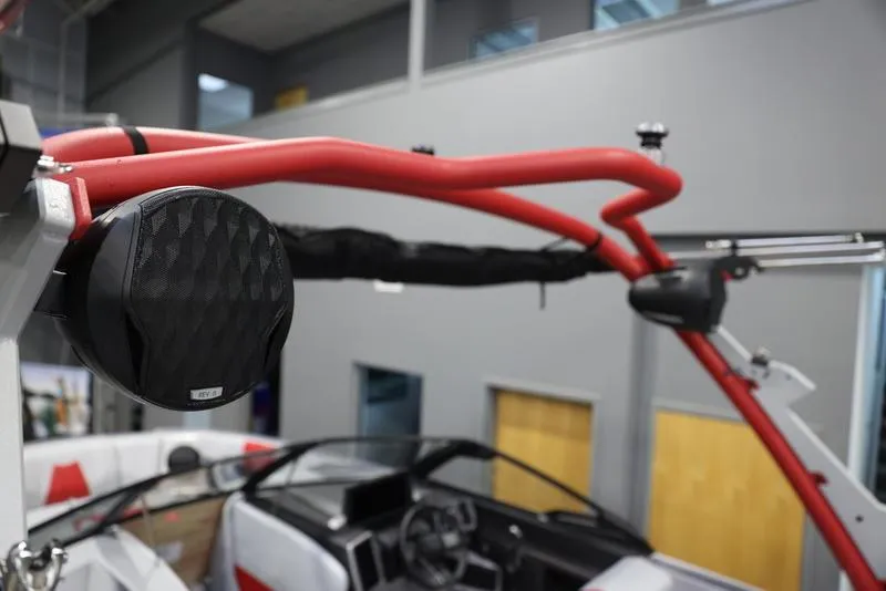 Slide: The Image of 2024 Malibu 24 MXZ boat with red wakeboard tower and speaker. - 10