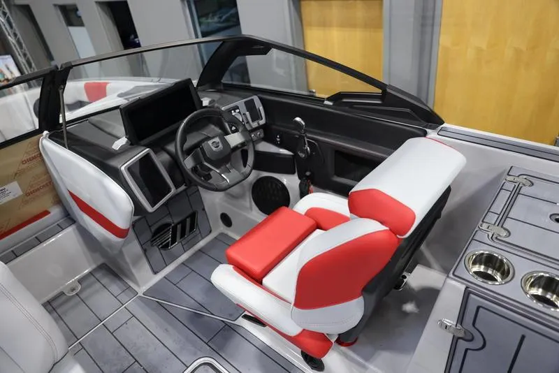 Slide: The Image of 2024 Malibu 24 MXZ boat interior with modern dashboard and red-white seating. - 11