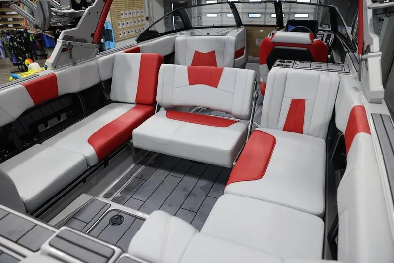Slide: The Image of 2024 Malibu 24 MXZ boat interior with red and white seating, spacious and modern design. - 16