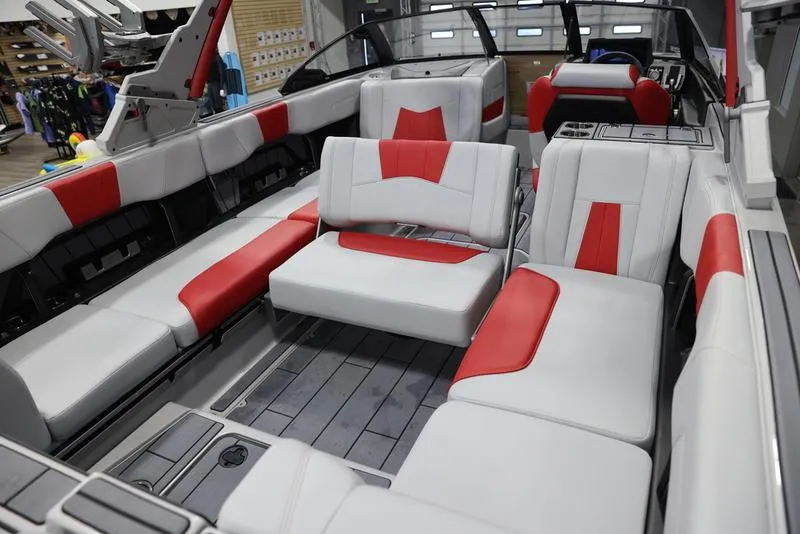 Slide: The Image of 2024 Malibu 24 MXZ boat interior with red and white seating. - 17