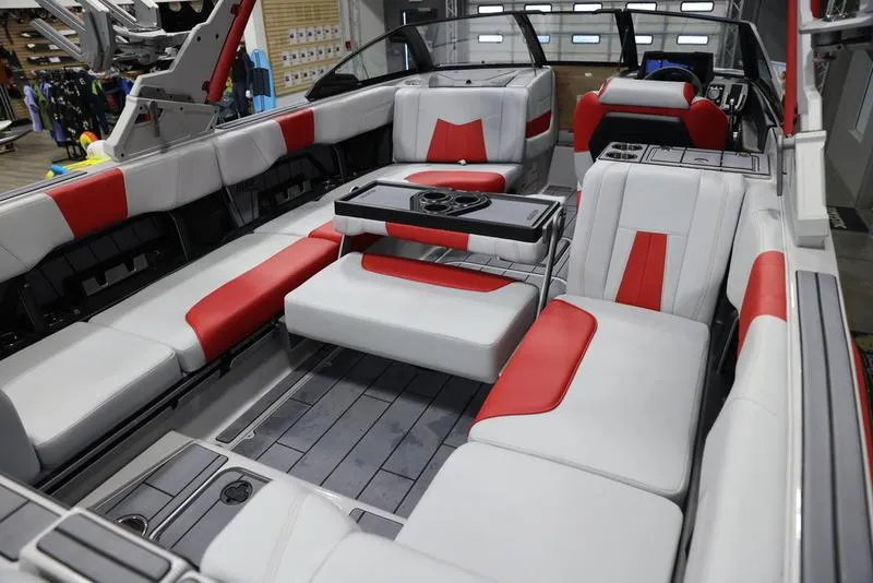 Slide: The Image of 2024 Malibu 24 MXZ boat interior with red and white seating, modern design. - 18