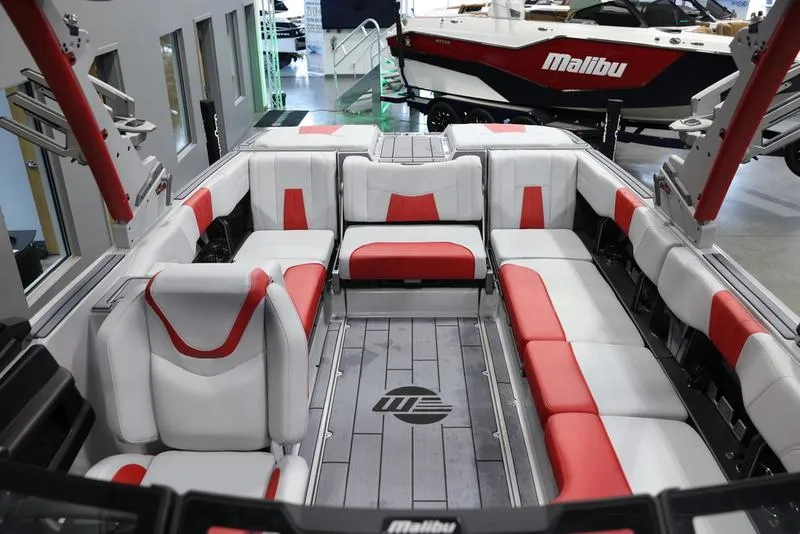 Slide: The Image of 2024 Malibu 24 MXZ boat interior with red and white seating, showcasing luxury design. - 21