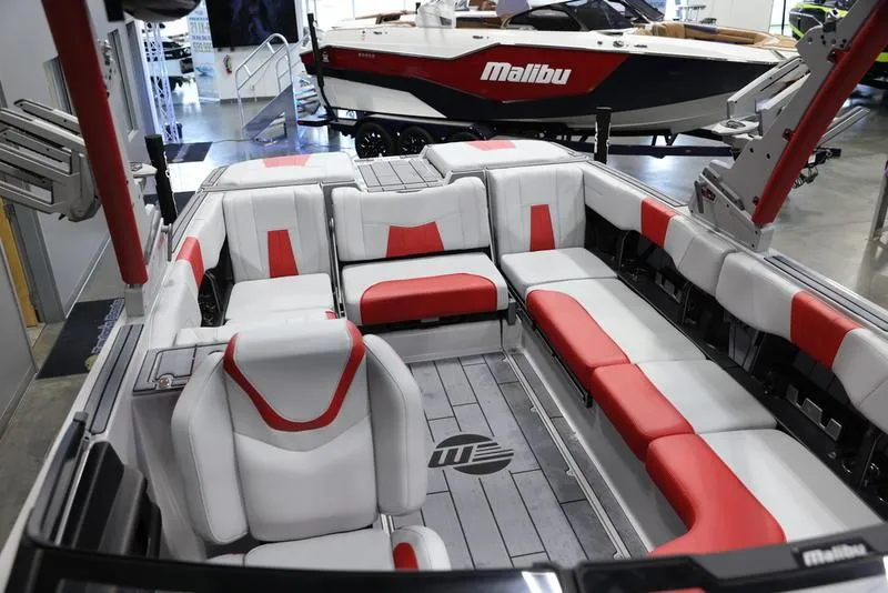Slide: The Image of 2024 Malibu 24 MXZ boat interior with red and white seating, showcasing luxury design. - 22