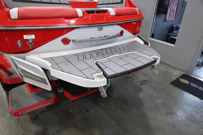 Slide: The Image of 2024 Malibu 24 MXZ boat rear view with swim platform in showroom. - 5