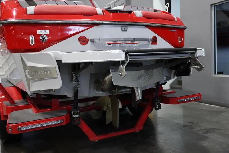 Slide: The Image of 2024 Malibu 24 MXZ boat rear view, showcasing red and white design with advanced features. - 6