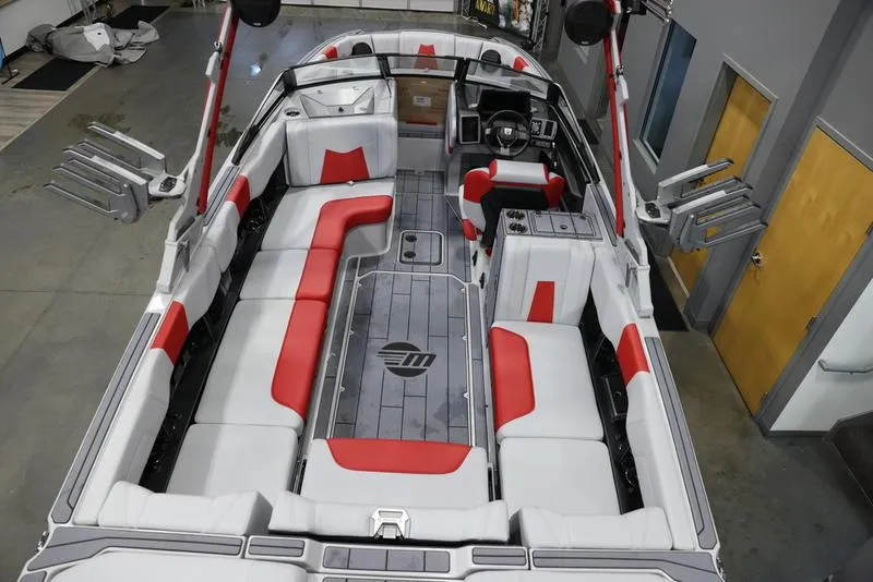Slide: The Image of 2024 Malibu 24 MXZ boat interior with red and white seating, spacious layout. - 9