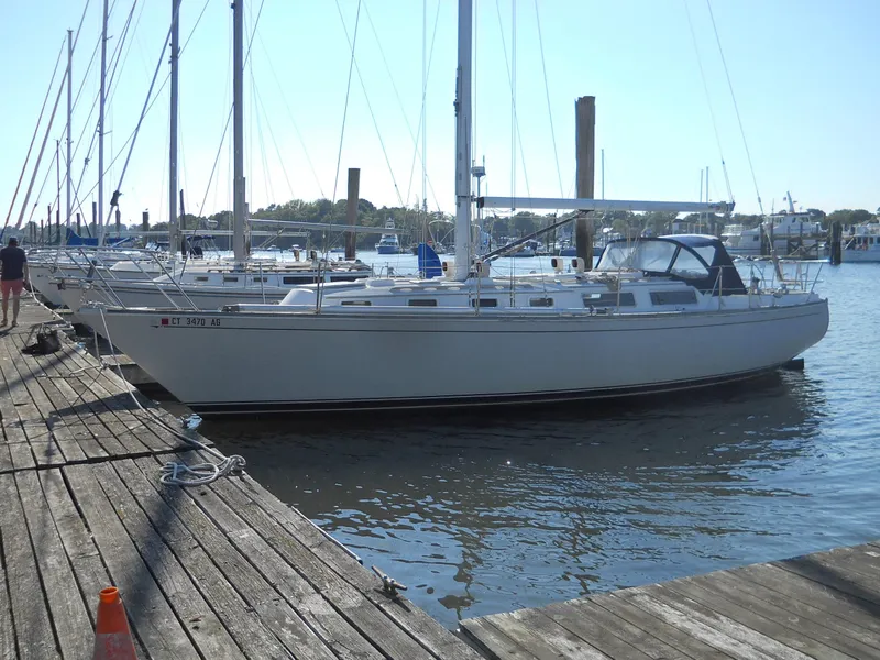 The Image of 1985 Sabre 38 MK I sailboat docked at a marina on a sunny day. - 1