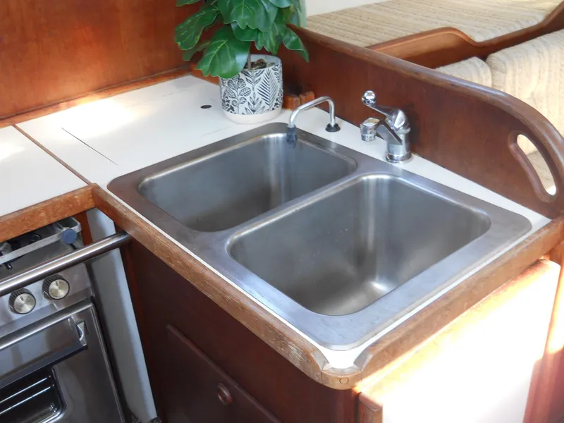 Slide: The Image of Double sink in a 1985 Sabre 38 MK I yacht kitchen with plant decor. - 10