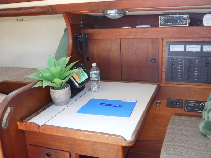 Slide: The Image of Navigation station in 1985 Sabre 38 MK I sailboat with desk, plant, and control panel. - 13