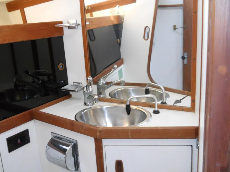 Slide: The Image of 1985 Sabre 38 MK I yacht bathroom with stainless steel sink and wooden accents. - 18