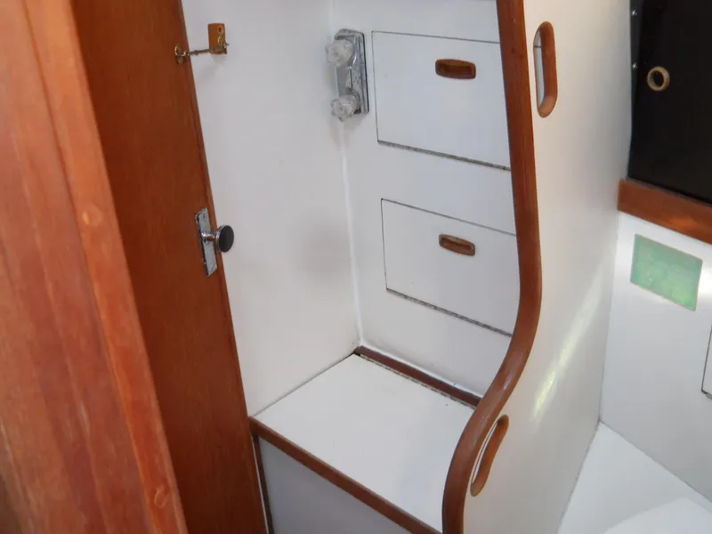 Slide: The Image of Interior of 1985 Sabre 38 MK I sailboat with wooden cabinetry and storage drawers. - 19