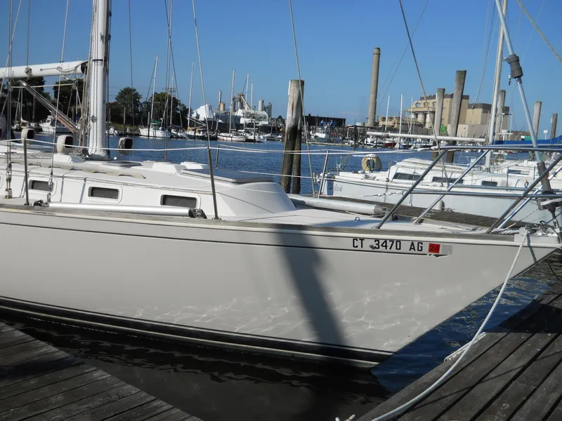 Slide: The Image of 1985 Sabre 38 MK I sailboat docked at a marina with clear blue skies. - 4