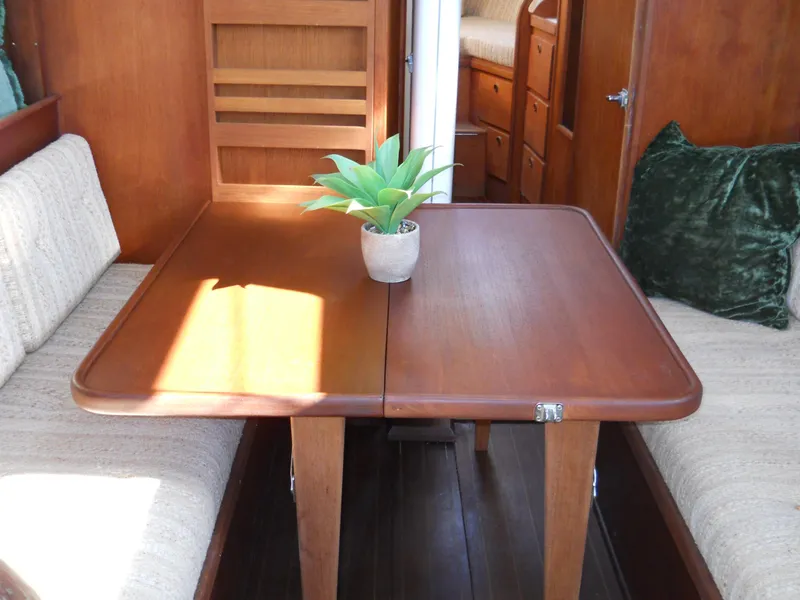Slide: The Image of Interior of 1985 Sabre 38 MK I sailboat with wooden table and seating. - 7