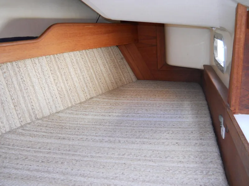 Slide: The Image of Interior cabin of 1985 Sabre 38 MK I sailboat with wood trim and striped upholstery. - 8