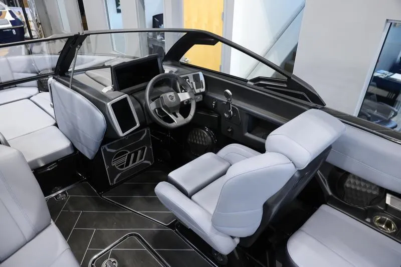 Slide: The Image of 2024 Malibu 23 LSV boat interior with modern dashboard and seating. - 11