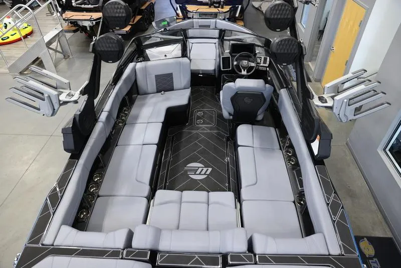 Slide: The Image of 2024 Malibu 23 LSV boat interior with sleek seating and modern design. - 12