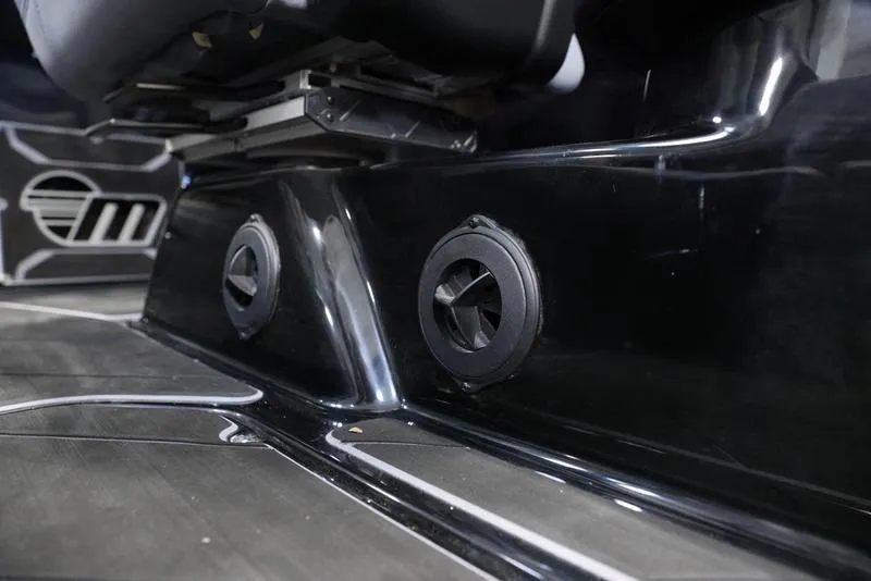 Slide: The Image of 2024 Malibu 23 LSV interior detail with sleek black finish and speaker vents. - 15