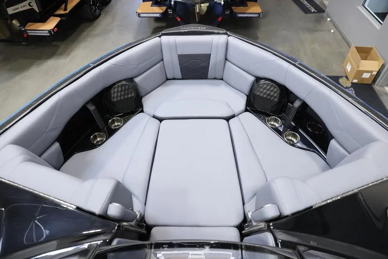 Slide: The Image of 2024 Malibu 23 LSV boat interior with luxurious seating and cup holders. - 18