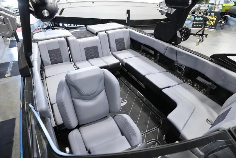 Slide: The Image of 2024 Malibu 23 LSV boat interior with luxurious gray seating and modern design. - 23