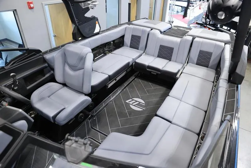 Slide: The Image of 2024 Malibu 23 LSV boat interior with luxurious gray seating and modern design. - 24