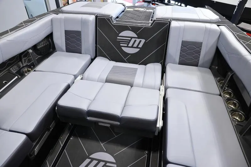 Slide: The Image of 2024 Malibu 23 LSV boat interior with luxurious gray seating and modern design. - 25