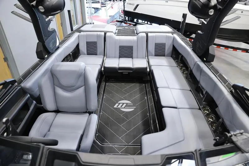 Slide: The Image of 2024 Malibu 23 LSV boat interior with spacious seating and modern design. - 26
