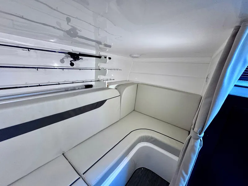 Slide: The Image of 2022 Stamas 370 Aegean cabin interior with white seating and fishing rod storage. - 16