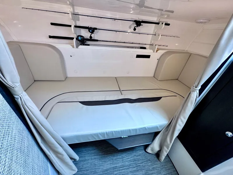 Slide: The Image of 2022 Stamas 370 Aegean cabin interior with fishing rods and cushioned seating. - 18