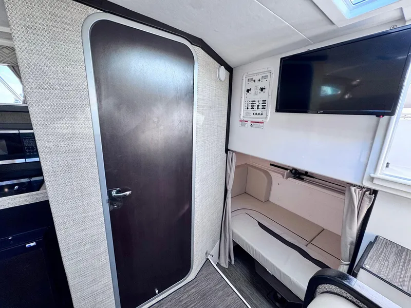 Slide: The Image of Interior of 2022 Stamas 370 Aegean boat with TV, seating, and door. - 22