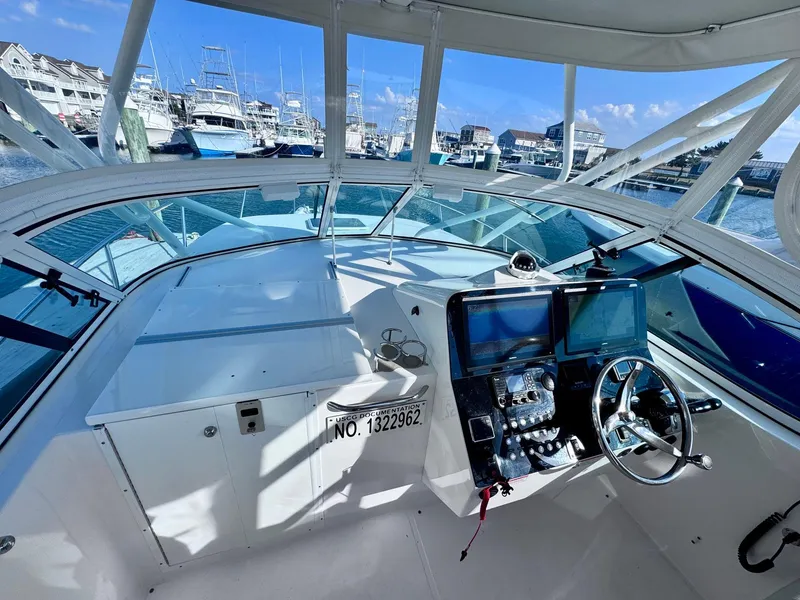 Slide: The Image of 2022 Stamas 370 Aegean boat cockpit with marina view, featuring modern navigation equipment. - 29